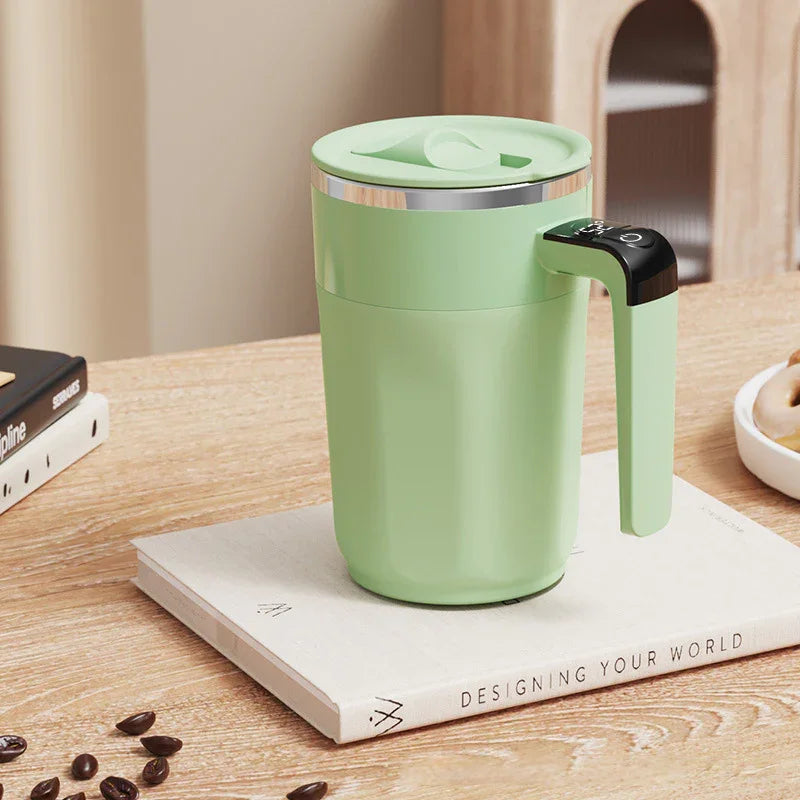 Green premium electric mug with handle on a book, modern homeware from clarioy