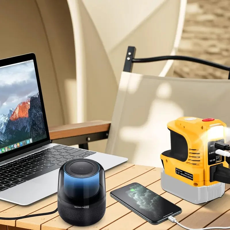 Portable power station charging laptop, speaker, and smartphone on outdoor table, electronics essentials from clarioy.