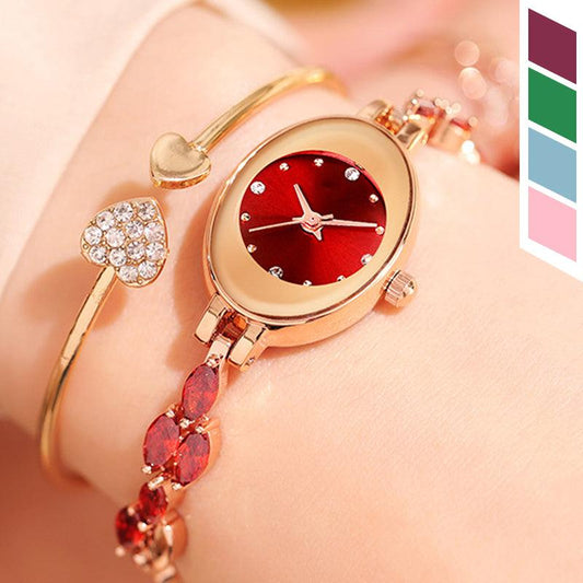 Elegant women's gold bracelet watch with red face and crystal heart charm, clarioy jewelry.