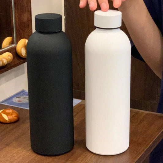 Black and white minimalist water bottles on wooden table, modern homeware at clarioy