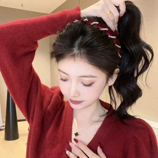 Woman in red sweater with pearl hair accessory, showing elegant homeware style from clarioy