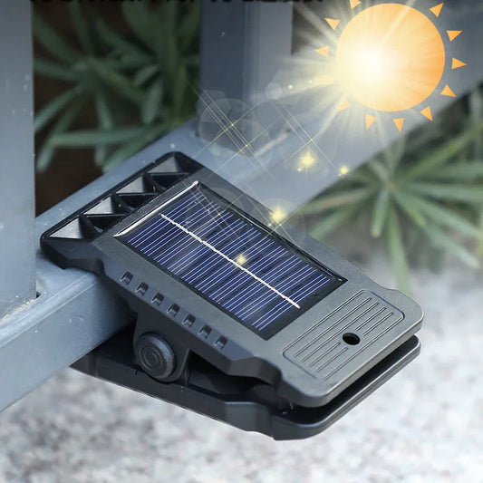 Outdoor solar-powered LED fence light clipped to railing, eco-friendly homeware from clarioy
