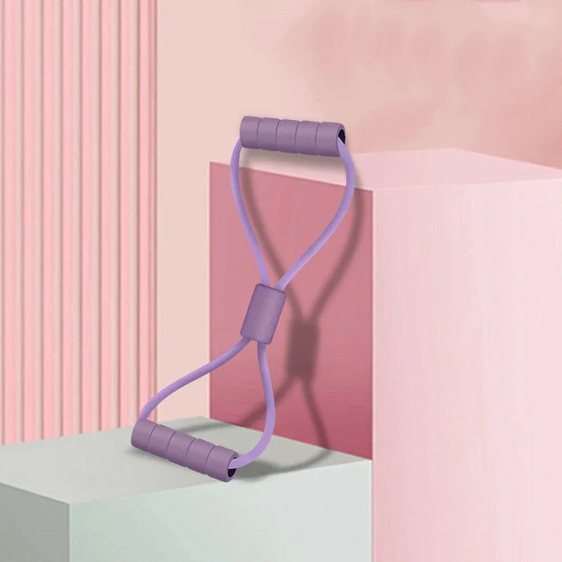 Purple resistance band with padded handles on pastel pink geometric blocks, clarioy auto tools and homeware