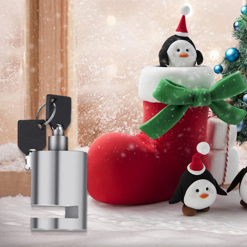 Stainless steel lock with keys next to festive Christmas stocking and penguin decorations, clarioy homeware.