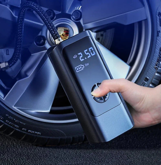 Person using digital portable tire inflator on car wheel, clarioy auto tool