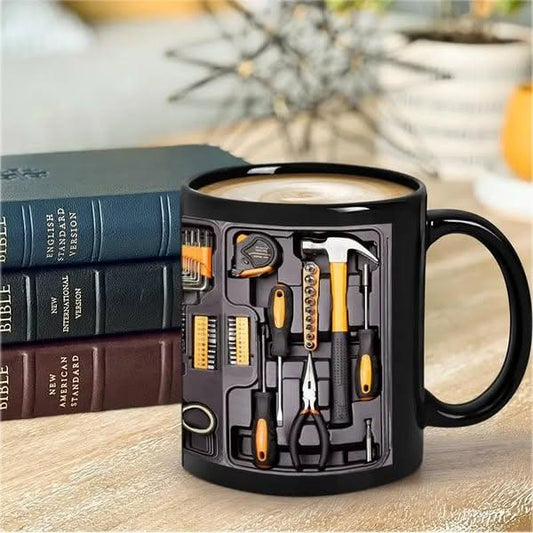 Black coffee mug with auto tool set graphic, on wood table by stacked books, clarioy homeware