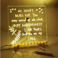 LED light up message board with anniversary love note, floral design, and marker on desk
