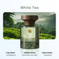 Arom Experience White Tea perfume bottle with green tea field background, highlighting top notes of lime and bergamot, middle notes of jasmine and lily of the valley, and base notes of amber and musk, premium home fragrance from clarioy.