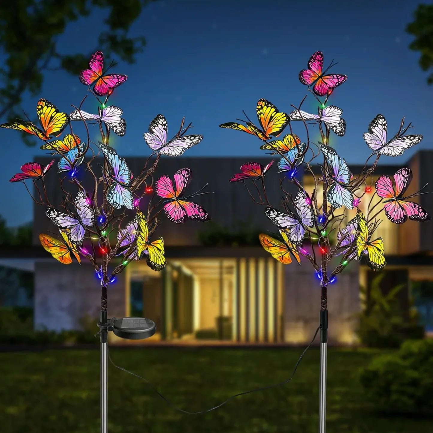 Colorful butterfly solar garden lights in front of modern house at night, clarioy outdoor decor