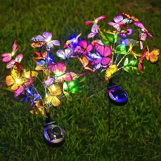 Solar powered butterfly garden lights glowing in colorful LED on grass, outdoor home decor from clarioy