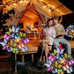 Couple relaxing at night by a lit tent with colorful butterfly solar garden lights, clarioy homeware
