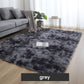 Grey shaggy area rug in modern living room with sofa, throw, indoor plant, and natural light