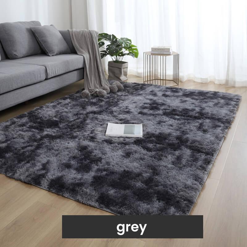 Grey shaggy area rug in modern living room with sofa, throw, indoor plant, and natural light