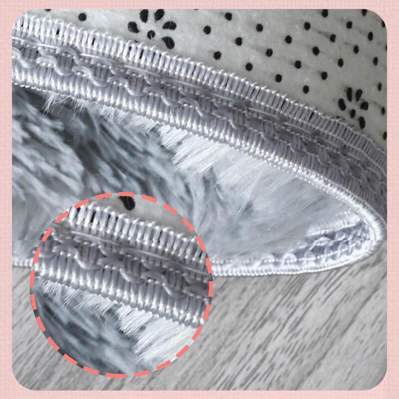 Close-up of a premium grey faux fur rug with detailed stitched edge, soft texture visible