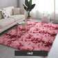 Red plush area rug in modern living room with beige sofa, plant, and decorative pillows, clarioy homeware.