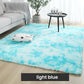 Light blue fluffy rug in modern living room with sofa, table, cushion, and plant from clarioy.
