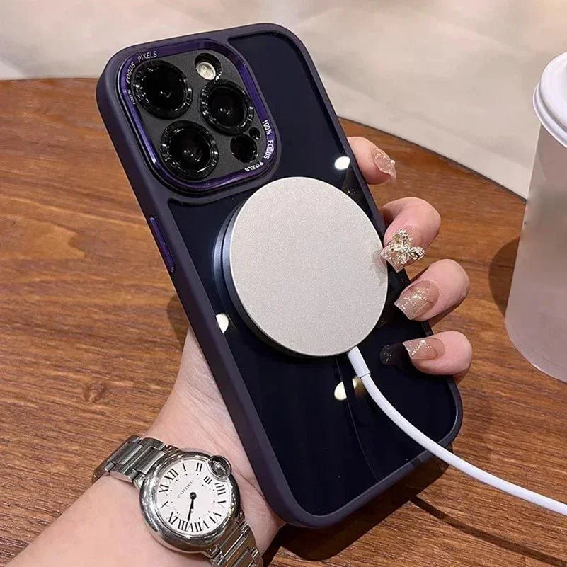 Person holding iPhone with purple case and wireless MagSafe charger on wooden table