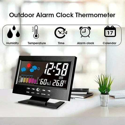 Digital outdoor alarm clock thermometer with humidity, temperature, calendar, and time display on desk