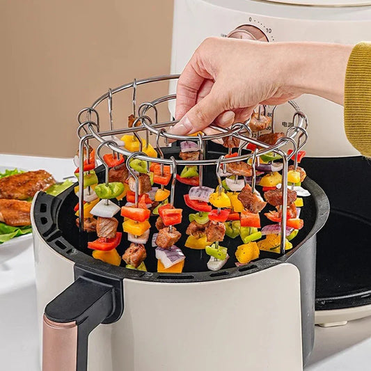 Hand placing skewers rack with meat and vegetables into air fryer, premium homeware from clarioy