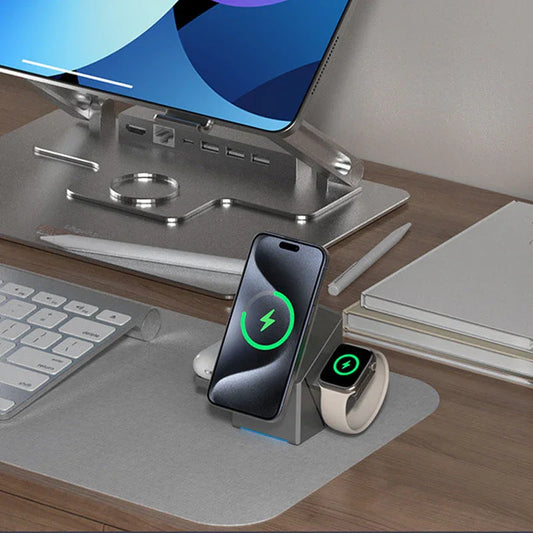 Wireless charger dock for iPhone and smartwatch on modern desk with keyboard, stylus, and laptop