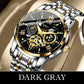 Luxury dark gray wristwatch with gold accents, stainless steel band, and exposed gears on display