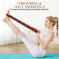 Woman using yoga stretch strap for flexibility exercise on mat, clarioy premium fitness accessory