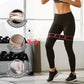 Woman using resistance band for leg workout in gym, clarioy fitness gear focus