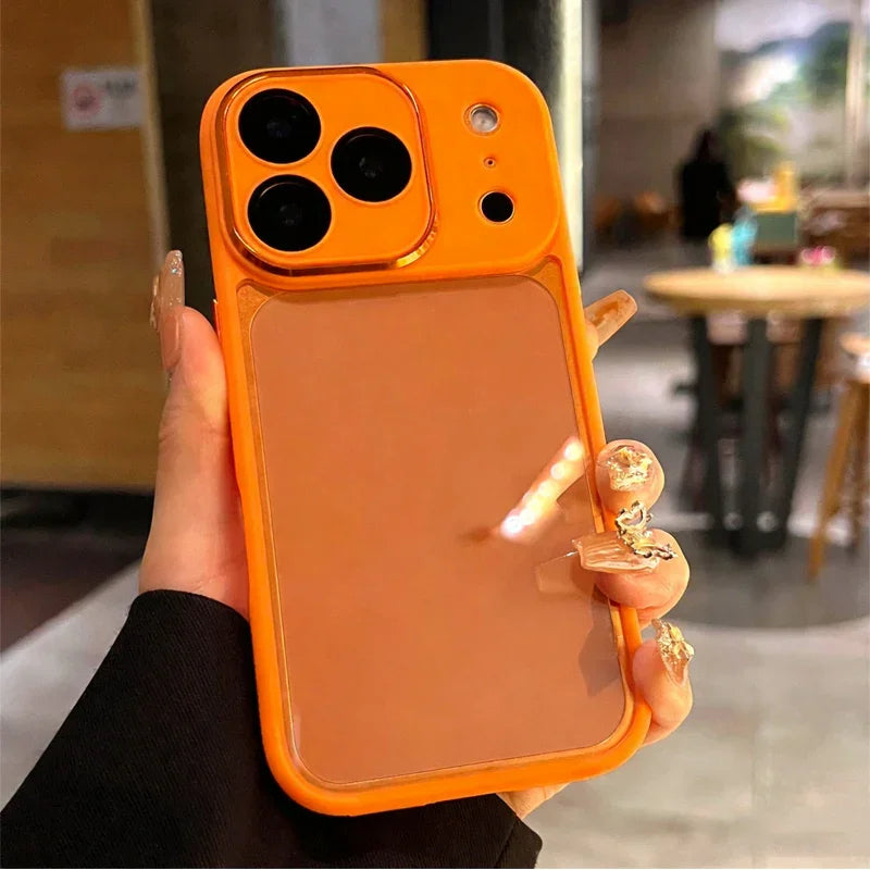 Hand holding orange mirror iPhone case, modern reflective phone cover, clarioy product