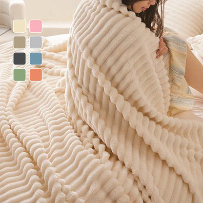 Soft ribbed fleece blanket in cream, draped over a person on a bed, clarioy homeware