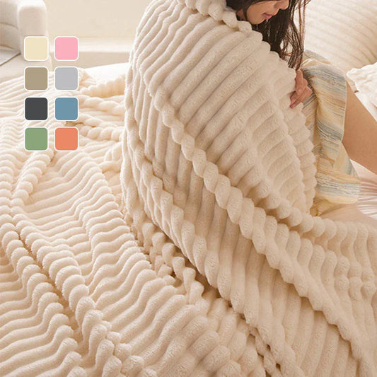 Soft ribbed fleece blanket in cream, draped over a person on a bed, clarioy homeware