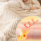 Woman sleeping under a plush cream blanket with insulation illustration, clarioy homeware