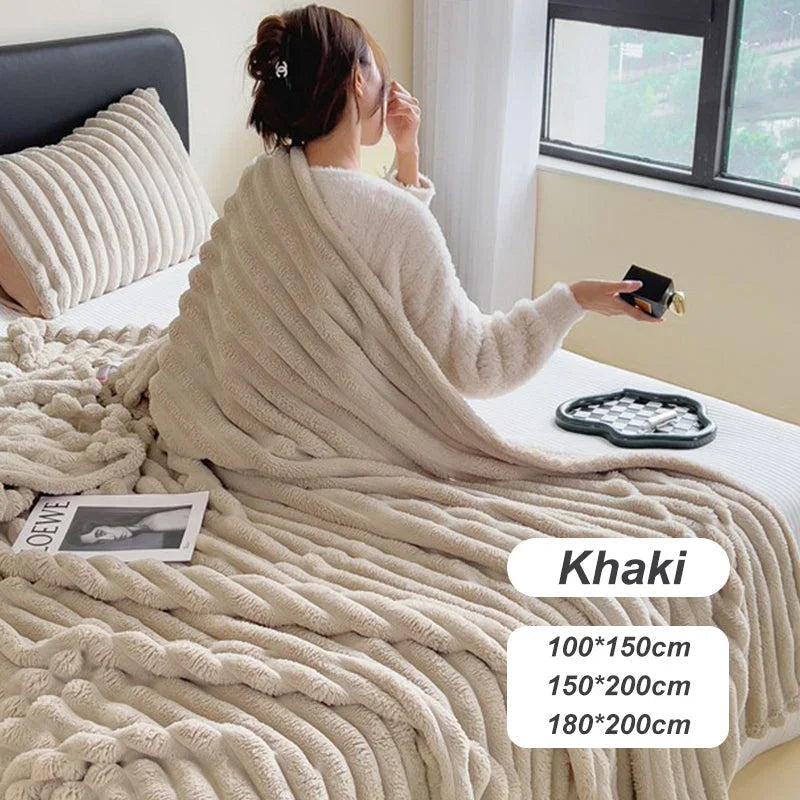 Woman relaxing with a soft khaki fleece blanket on bed, cozy homeware from clarioy