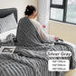 Woman sitting on bed with textured silver gray blanket, cozy homeware by clarioy.
