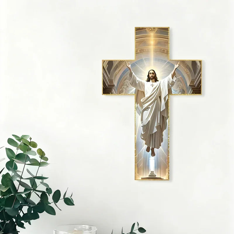 Wall-mounted cross decor with Jesus image, white background, plants and candle nearby