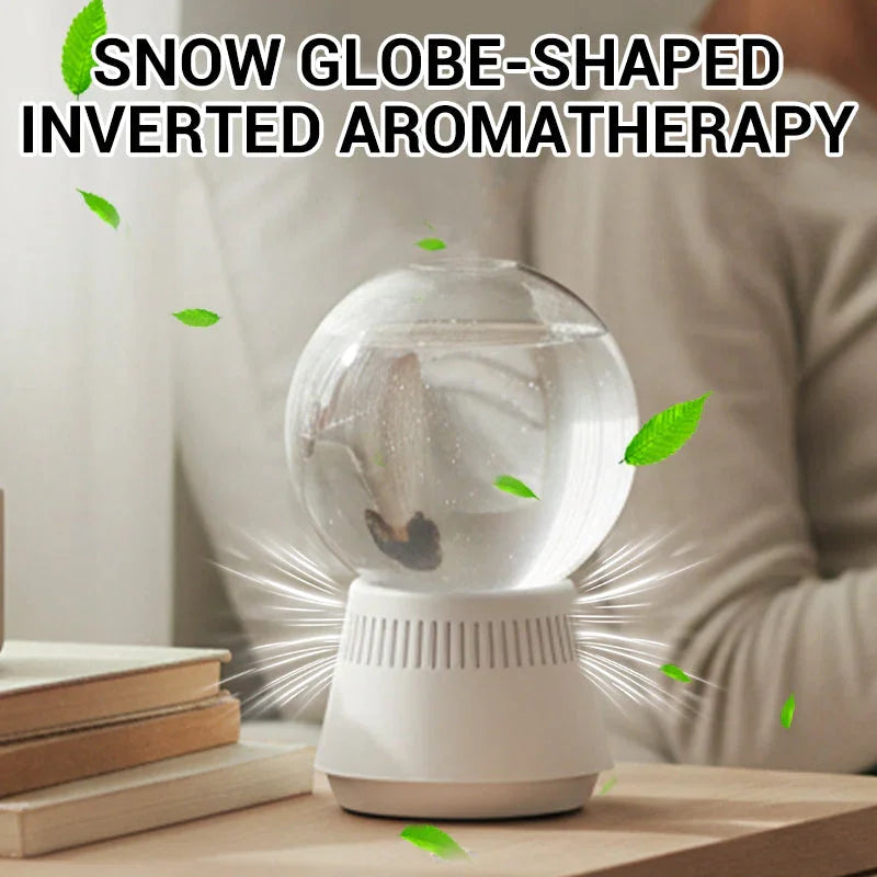 Snow globe-shaped inverted aromatherapy diffuser on desk, modern homeware by clarioy