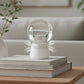Modern crystal globe lamp on stacked books in cozy living room, stylish clarioy homeware