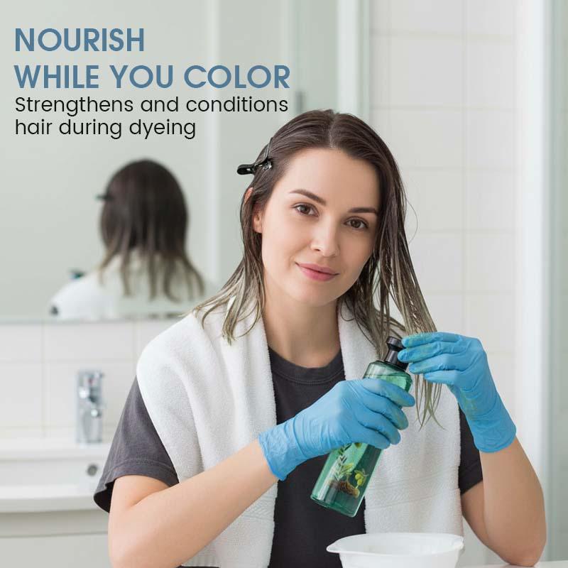 Woman applying nourishing hair treatment before coloring, wearing gloves in bathroom