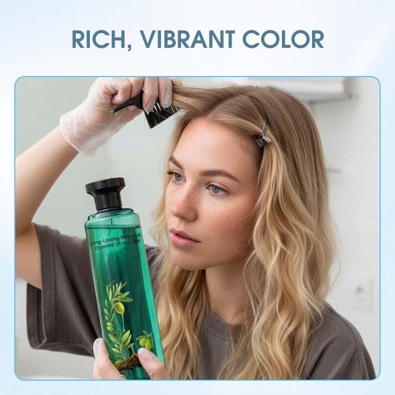 Woman applying hair dye with brush, holding green bottle labeled essential oil, in bright bathroom