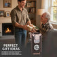 Smiling man gives gift box to older man, fireplace background, clarioy premium auto tool in foreground, perfect gift