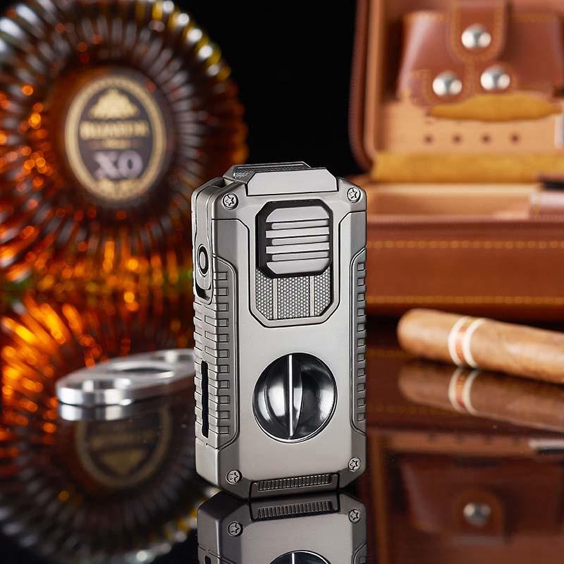 Premium metal cigar cutter with rugged design on reflective surface, whiskey bottle and cigar in background from clarioy shop