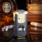 Luxury carbon fiber and gold torch cigar lighter with cigar, bottle, and case in background