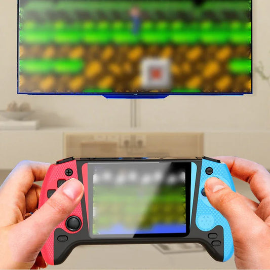 Hands holding a portable gaming console with red and blue controls, playing on a TV screen in a modern living room