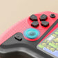 Close-up of a red and black handheld gaming console controller with textured grip, displayed game screen, and responsive joystick, featured on clarioy for electronics and gaming accessories.
