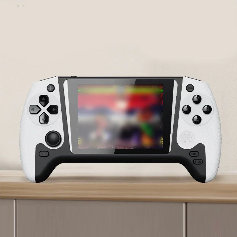Portable handheld gaming console with white and black design on a wooden shelf
