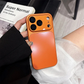 Orange iPhone case with card holder, held in hand, modern homeware setting, clarioy