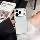 Hand holding silver iPhone with a sleek protective case, modern design by clarioy