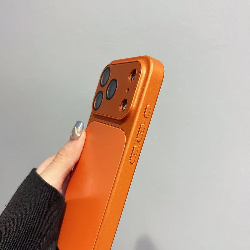 Hand holding orange iPhone case, premium phone accessory from clarioy