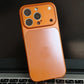 Orange iPhone case on laptop keyboard, clarioy electronics accessory