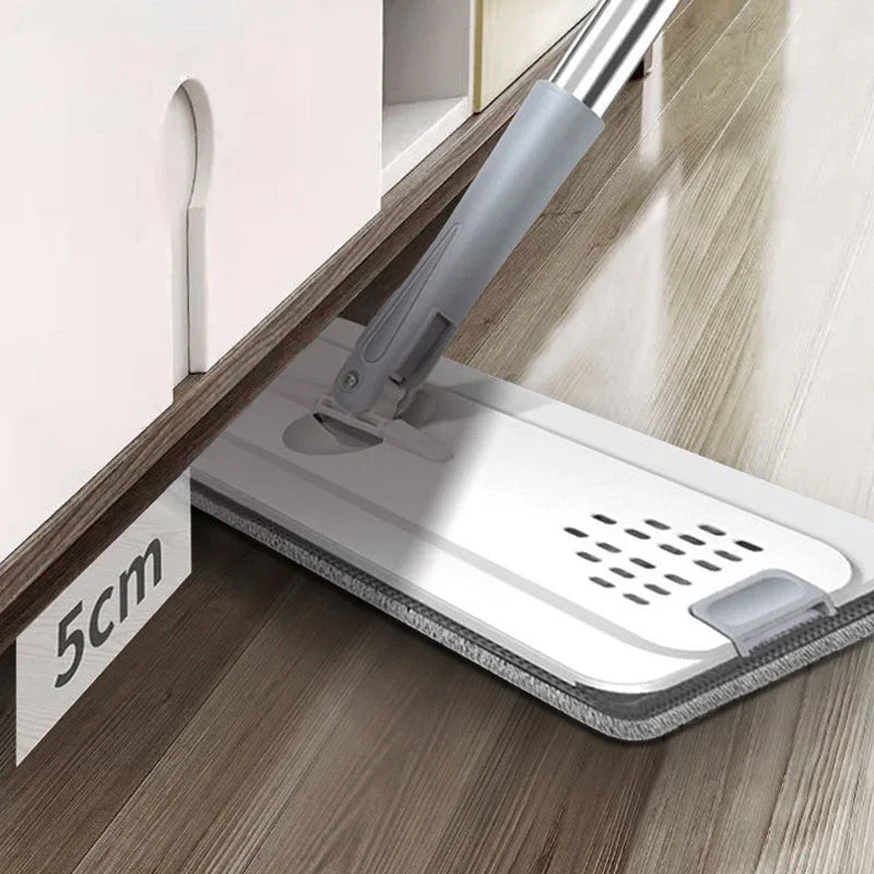 Slim cleaning mop with gray handle cleaning under a cabinet with 5cm clearance on wood floor