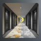 Modern hallway with geometric tiles, half in color and half in grayscale, yellow crescent moon art
